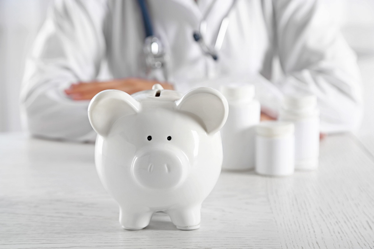© Africa Studio - stock.adobe.com Arzt hinter Sparschwein